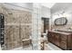 Modern bathroom showcasing a glass block shower, tiled walls, and vanity with ample storage space at 7280 E Patricia Dr, Camby, IN 46113