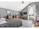 Spacious bedroom featuring vaulted ceilings, modern decor, and a cozy rocking chair by a window at 7280 E Patricia Dr, Camby, IN 46113