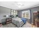 Comfortable bedroom with gray walls, white trim, and plenty of natural light from the bright window at 7280 E Patricia Dr, Camby, IN 46113