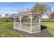 Charming white gazebo with seating on a well-manicured lawn perfect for outdoor relaxation and enjoyment at 7280 E Patricia Dr, Camby, IN 46113
