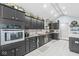 Modern kitchen with sleek black cabinets, stainless steel appliances, and granite countertops at 7280 E Patricia Dr, Camby, IN 46113