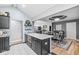Open kitchen with island featuring seating, leading to an adjacent dining area at 7280 E Patricia Dr, Camby, IN 46113