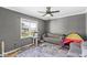 Bright living room with cozy sofa, cat tower, and ample natural light overlooking gazebo at 7280 E Patricia Dr, Camby, IN 46113