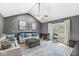 Inviting living room with vaulted ceiling, comfortable seating, and French doors leading to the outside at 7280 E Patricia Dr, Camby, IN 46113