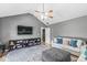 Relaxing living room featuring a vaulted ceiling, plush sofa, and entertainment center at 7280 E Patricia Dr, Camby, IN 46113