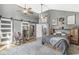 Spacious main bedroom with unique barn door, ensuite bath, hardwood floors, and ample natural light at 7280 E Patricia Dr, Camby, IN 46113