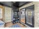 Cozy sunroom featuring brick walls, and a glass door that offers a view into other parts of the home at 7280 E Patricia Dr, Camby, IN 46113