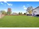 Expansive backyard with lush green grass and a wooden fence, perfect for outdoor activities at 825 Palisades Ct, Greenwood, IN 46143