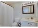 Bathroom with white vanity, toilet, shower with curtain, and mirror at 825 Palisades Ct, Greenwood, IN 46143