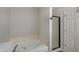 Bathroom featuring a bathtub, glass shower, and white door at 825 Palisades Ct, Greenwood, IN 46143