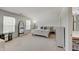Bright main bedroom with two windows, neutral carpet, large bed, and ensuite bathroom at 825 Palisades Ct, Greenwood, IN 46143