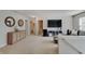 Open bonus room boasts neutral carpet, modern furniture and decor, and easy access to multiple rooms at 825 Palisades Ct, Greenwood, IN 46143
