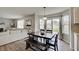 Warm dining area with dark wood table, bench seating, and natural light by the sliding doors at 825 Palisades Ct, Greenwood, IN 46143