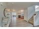 Welcoming foyer with hardwood floors and staircase leading to the upper level at 825 Palisades Ct, Greenwood, IN 46143