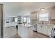 Bright kitchen with white cabinetry, stainless appliances, and open layout to the living area at 825 Palisades Ct, Greenwood, IN 46143