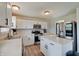 Modern kitchen featuring stainless steel appliances, white cabinets, and ample counter space at 825 Palisades Ct, Greenwood, IN 46143