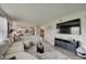 Cozy living room features an open floorplan, plush sectional sofa, modern fixtures, and views of kitchen and dining area at 825 Palisades Ct, Greenwood, IN 46143