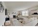 Bright living room features a fireplace, large sectional sofa, and ample natural light from the windows at 825 Palisades Ct, Greenwood, IN 46143