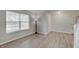 Neat room with hardwood floors, a large window, neutral wall paint, and entry way at 825 Palisades Ct, Greenwood, IN 46143