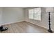 Minimalist room featuring hardwood floors, a large window, and neutral wall paint at 825 Palisades Ct, Greenwood, IN 46143