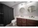 Bathroom with double sink vanity, shower, and modern lighting at 844 Fireside Dr, Greenwood, IN 46143