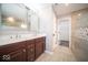Modern bathroom with double sink vanity, elegant mirrors, and tiled shower at 844 Fireside Dr, Greenwood, IN 46143