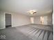 Enormous main bedroom boasts plush carpeting, neutral walls, and a ceiling fan at 844 Fireside Dr, Greenwood, IN 46143