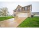 Two story home features a two car garage, brick and siding and a well maintained lawn at 844 Fireside Dr, Greenwood, IN 46143