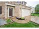 The front entrance of this home features a brown front door with sidelights and manicured landscaping at 844 Fireside Dr, Greenwood, IN 46143