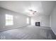 Spacious living room featuring a fireplace, ceiling fan, and abundant natural light at 844 Fireside Dr, Greenwood, IN 46143