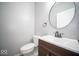 This powder room has a modern vanity, round mirror, and sleek fixtures at 844 Fireside Dr, Greenwood, IN 46143