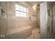 Luxurious walk-in shower features stylish tiling, a bench, and a rainfall showerhead at 844 Fireside Dr, Greenwood, IN 46143