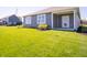 Home with large, well-maintained backyard, tidy landscaping, and a covered patio at 8502 Hemingway Dr, Indianapolis, IN 46239