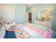 Bright bedroom with colorful quilt, white dresser, and light blue walls, providing a cozy and inviting space at 8502 Hemingway Dr, Indianapolis, IN 46239
