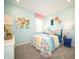 Stylish bedroom featuring aqua walls, colorful bedding, and decor at 8502 Hemingway Dr, Indianapolis, IN 46239