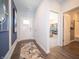Bright entryway with modern wood flooring and views to a home office and bathroom at 8502 Hemingway Dr, Indianapolis, IN 46239