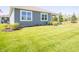 Home exterior with tidy landscaping and a lush green lawn on a sunny day at 8502 Hemingway Dr, Indianapolis, IN 46239