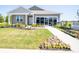 Charming single-story home featuring a manicured lawn, inviting walkway, and blooming flowerbeds at 8502 Hemingway Dr, Indianapolis, IN 46239