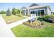 Attractive home exterior features a neat lawn, blooming flowerbeds, and clear community signage at 8502 Hemingway Dr, Indianapolis, IN 46239