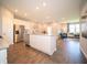 Open concept: kitchen and living area showcasing stainless steel appliances, a kitchen island and wood floors at 8502 Hemingway Dr, Indianapolis, IN 46239