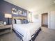 Comfortable main bedroom showcasing a decorative blue accent wall and elegant furnishings at 8502 Hemingway Dr, Indianapolis, IN 46239