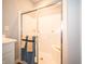 Bathroom shower stall features sliding glass doors, seat, and coordinated towels at 8502 Hemingway Dr, Indianapolis, IN 46239