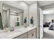 Bathroom features a double vanity, a mirror, and an open door that reveals the main bedroom at 8583 Strabet Dr, Pendleton, IN 46064