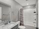 Well-lit bathroom boasts a shower-tub combination, a vanity with a sink, and modern fixtures at 8583 Strabet Dr, Pendleton, IN 46064