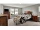 Cozy bedroom with a large bed, matching wooden furniture, and a view of the neighborhood at 8583 Strabet Dr, Pendleton, IN 46064