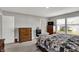 Bright bedroom showcases wood furniture and a view of the neighborhood through large windows at 8583 Strabet Dr, Pendleton, IN 46064