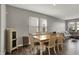 Open-concept dining room with wood floors, light gray walls, and modern furnishings at 8583 Strabet Dr, Pendleton, IN 46064