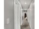 Bright hallway features neutral paint and carpet, leading to rooms and closets at 8583 Strabet Dr, Pendleton, IN 46064