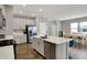 Open kitchen with stainless steel appliances, island with seating, and adjacent dining area perfect for entertaining at 8583 Strabet Dr, Pendleton, IN 46064
