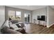 Living room with hardwood floors, gray walls, and a large sectional sofa at 8583 Strabet Dr, Pendleton, IN 46064